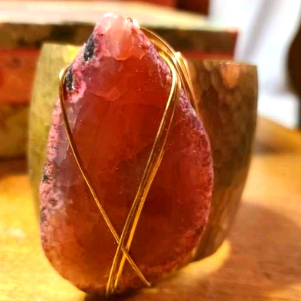 Brass cuff bracelet with pink stone.